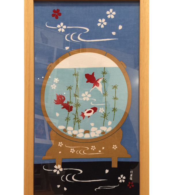 Japanese material that has been framed in a pine frame with a lacquered finish and glass.