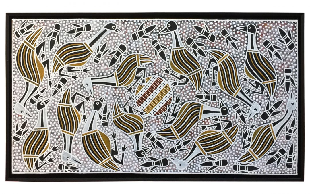 A large Aboriginal painting stretched on to a timber frame and then framed in a black matte floater frame.