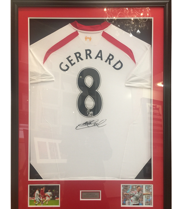 A Liverpool jersey signed by Luis Suariz with double mat board, photos and plaque.