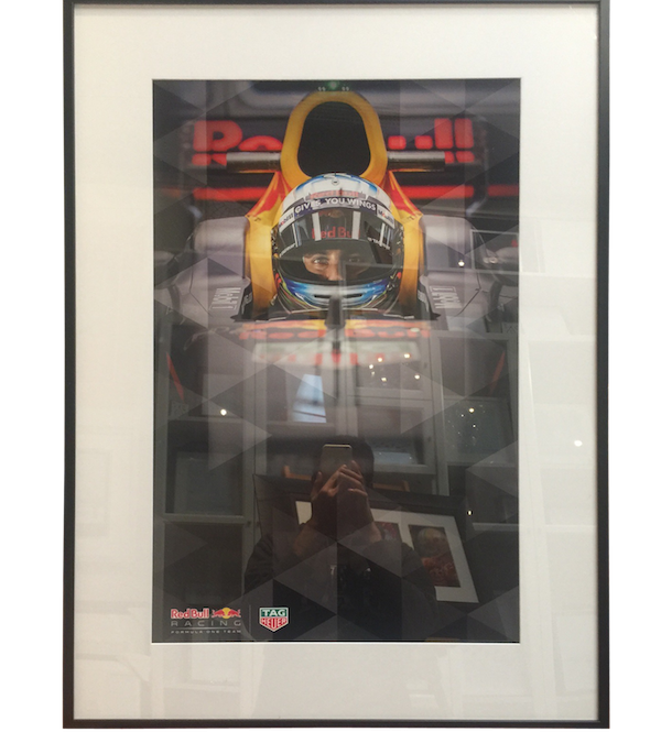 A promotional photo of Grand Prix sponsorship for TagHeuer framed in a narrow box frame with mat board surround and plexiglas.
