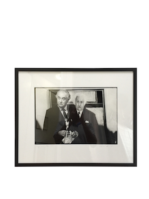 A photo of Gough Whitlam framed in black timber frame with double mat board surround.