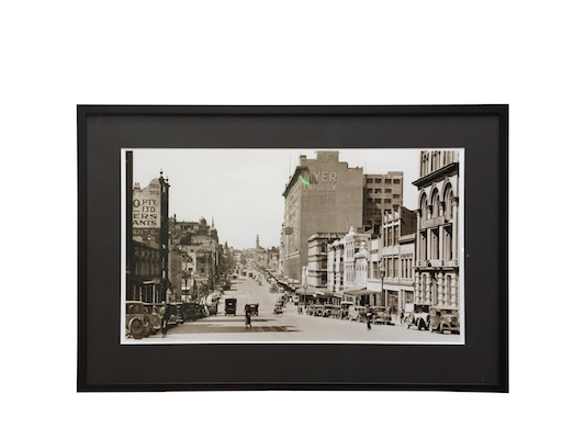 An old Melbourne street photograph reframed in a black box frame with a mat board surround.