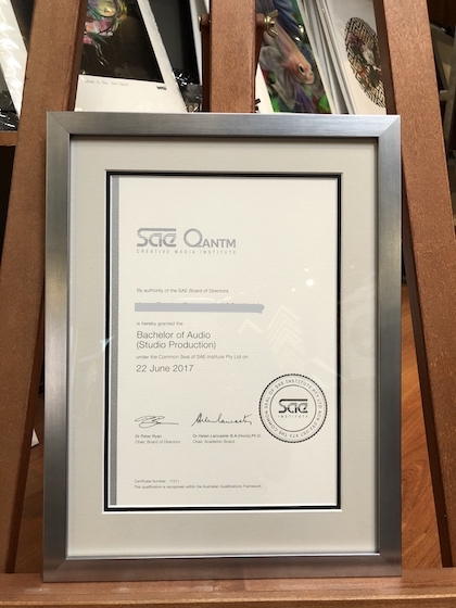 A certificate framed in a silver wooden metallic frame with a double mat board surround and UV glass.