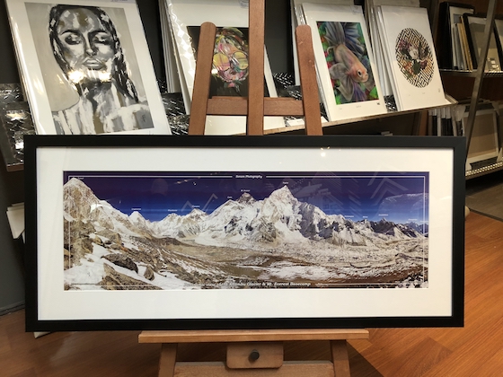 A large Mount Everest map print framed in a black wooden frame with a mat board surround and UV glass.