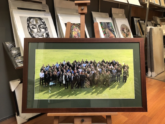 A large photo printed by Mahoneys framed in a flat walnut frame with mat board surround and glass.