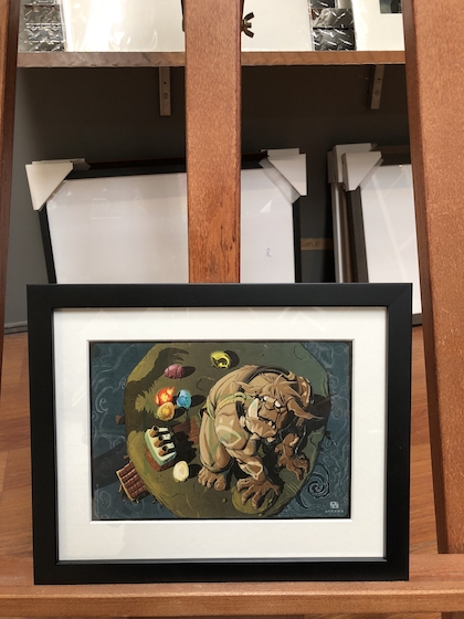 A small animation print framed in a black timber frame with white mat board surround and UV glass.