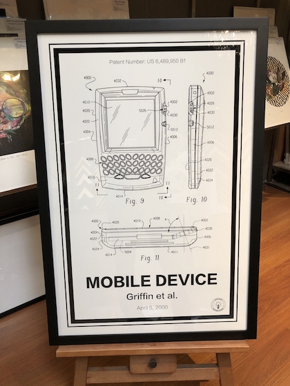 A patent poster framed in a wide black box frame with a double mat board surround and UV glass.