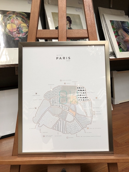 A Paris map print framed in a soft gold timber frame with glass.