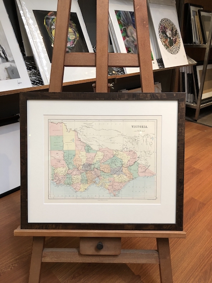 An old Victorian map framed in a birds eye veneer frame with a mat board surround and museum glass.