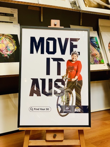 A Sport Aus promotional print framed in a black box frame with glass.