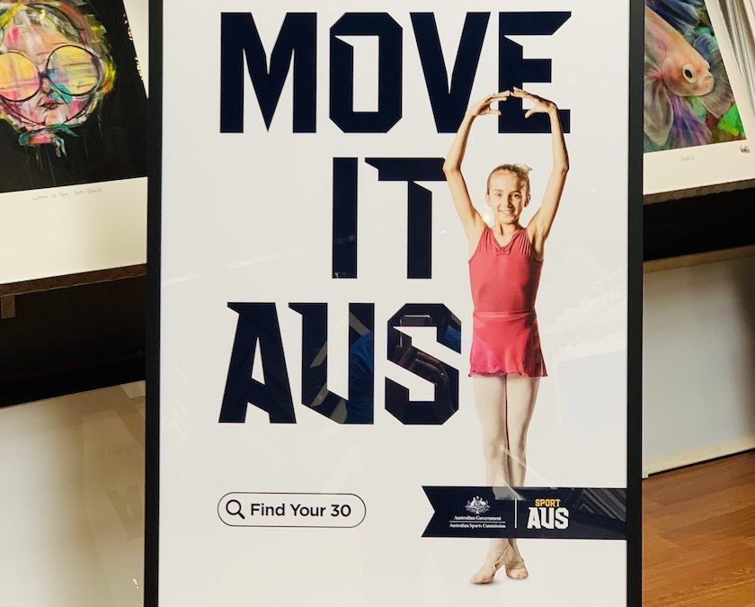 A ballet Sport Aus promotional print part of the Move It Aus campaign framed in a black box frame with glass.