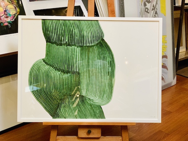 A contemporary green abstract print framed in a white box frame with glass.