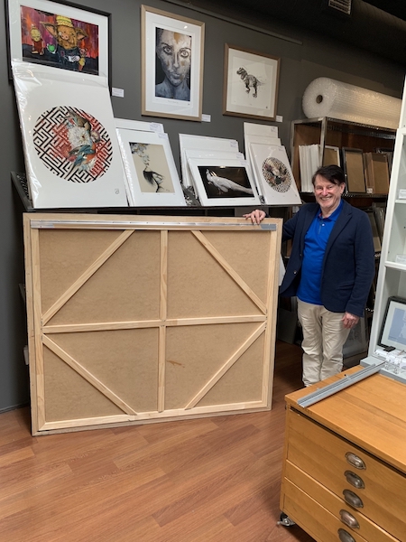 Greg Mahoney displaying the back of a large floater frame.