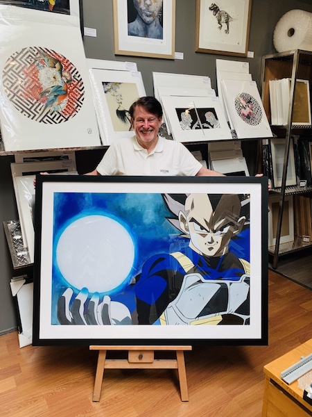 A Dragon Ball Z poster framed in a black timber frame with glass.
