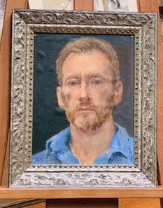 A small self portrait framed on board framed in a silver ornate frame