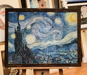 A Van Gough print of Starry Night framed in a walnut veneer frame with glass