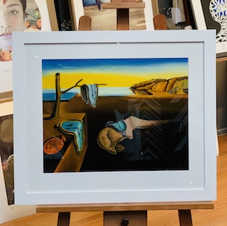 An oil on canvas based on a classic Salvador Dali painting that we framed in a wide white frame with a white mat board surround and glass