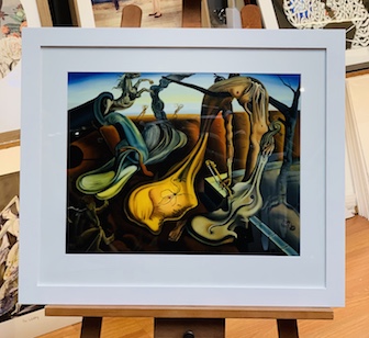 This was a painting that our client had painted that was of a Dali painting. The frame and mat are white and we put glass on the work