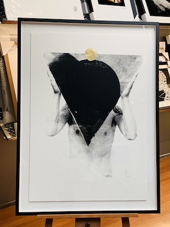 An out-there black and white limited edition print raised and then floated on a mat board back. We have then used a black box frame and then we sit the artwork towards the back of the frame