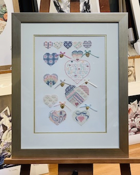 This is a exquisite little needlework that we have stretched and then framed in an elegant silver frame, double mat surround and glass
