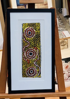 A small indigenous artwork on canvas. The painting was way out of square so we decided to float the painting on a mat board surround then added a mat, frame and glass. It looks good!