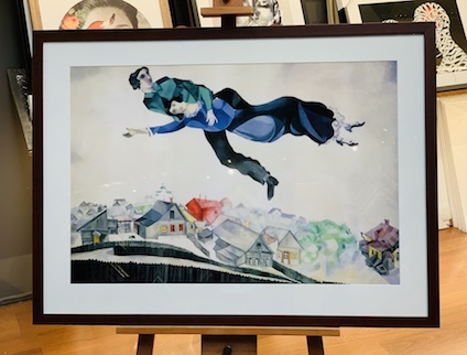 This is a classic Marc Chagall print which we have framed in a square black frame, mat surround and glass