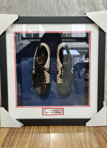Black box frames are excellent for cherished memorabilia like a pair of signed football boots. This lucky fan framed a signed football boots with double matboards and customised plaques that match the colours of the Melbourne Demons team, leaving the client very delighted with its finished look.